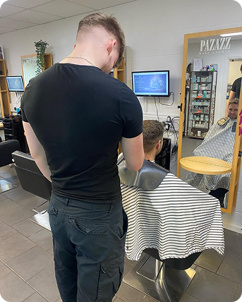 a male barber giving a male customer a haircut